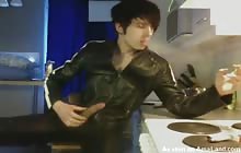 Leather clad twink jerks off while smoking