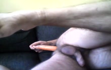 Inserting a carrot up his ass
